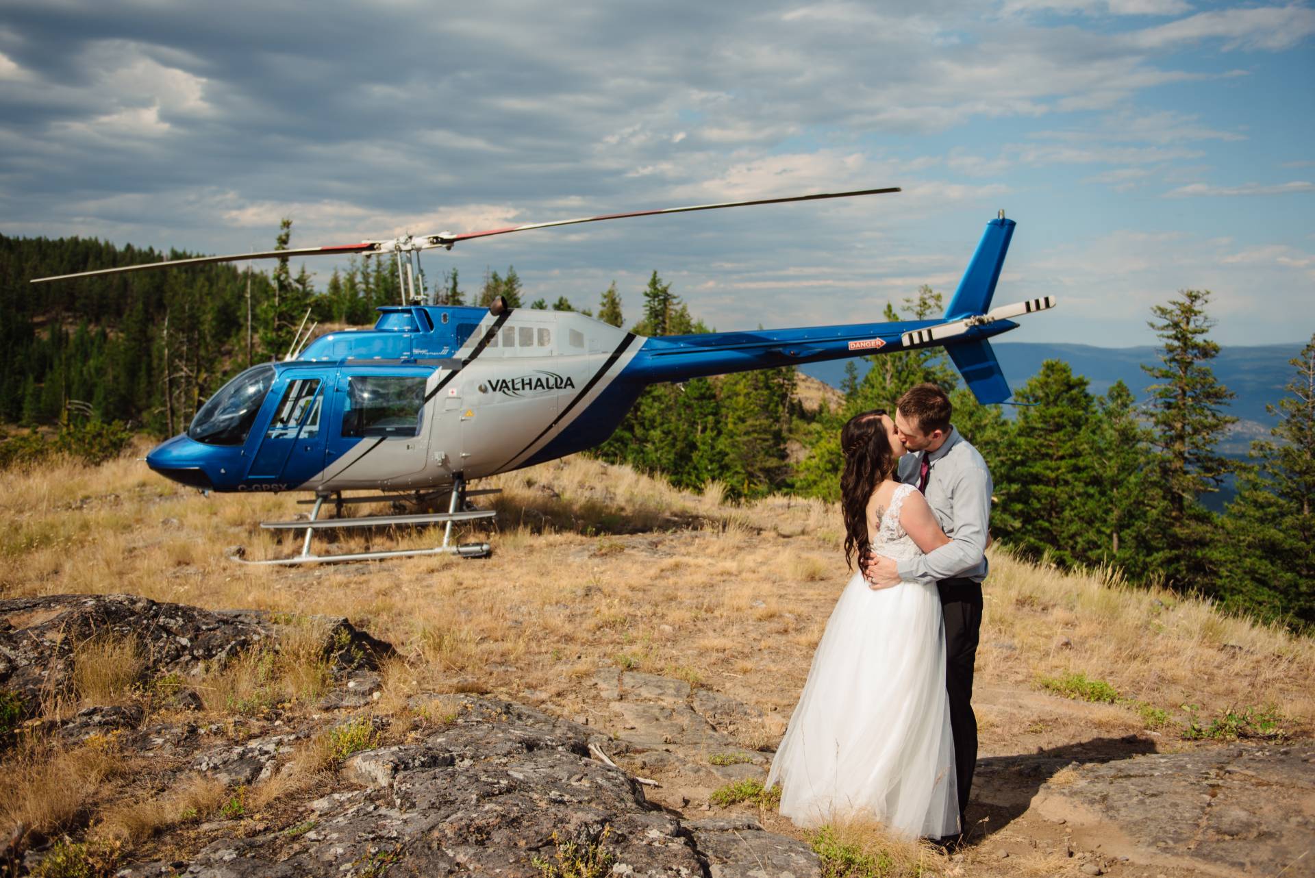 Unique wedding ideas - helciopter wedding day picture next to a helicopter